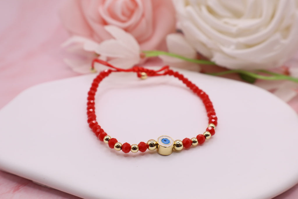 Pulseras tejidas en hilo rojo con cuentas de cristales y balines en baño de oro 18k